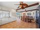 Kitchen transitions to dining area; rustic wooden furniture accents the tile flooring at 6112 Gnarled Oak Dr, Englewood, FL 34223