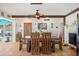 Dining room with rustic table, wooden chairs, and a decorative light fixture at 6112 Gnarled Oak Dr, Englewood, FL 34223