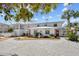 Charming two-story home with lush landscaping, brick driveway, and a quaint fountain at 6112 Gnarled Oak Dr, Englewood, FL 34223