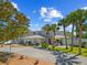 Attractive home with a well-manicured lawn and stone driveway, complemented by mature palms at 6112 Gnarled Oak Dr, Englewood, FL 34223