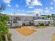 Stately home with a circular driveway and balcony, offering a glimpse of beachside living at 6112 Gnarled Oak Dr, Englewood, FL 34223