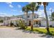 Gorgeous two story home with driveway, lush landscaping, and outdoor seating area at 6112 Gnarled Oak Dr, Englewood, FL 34223