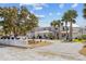 Charming two-story home with a well-manicured front yard, circular driveway, and white picket fence at 6112 Gnarled Oak Dr, Englewood, FL 34223