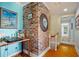 Hallway featuring a brick corner, and view to a bedroom with hardwood floors and a desk space at 6112 Gnarled Oak Dr, Englewood, FL 34223