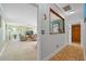 Hallway entrance to living room featuring tile flooring and neutral walls at 6112 Gnarled Oak Dr, Englewood, FL 34223
