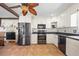 Kitchen with stainless steel appliances, breakfast bar and adjacent dining area at 6112 Gnarled Oak Dr, Englewood, FL 34223