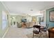 Inviting living room featuring tile floors, comfortable seating, and seamless indoor-outdoor flow to the pool area at 6112 Gnarled Oak Dr, Englewood, FL 34223
