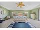Bright main bedroom featuring a vaulted ceiling, fan, and an inviting coastal-themed bed at 6112 Gnarled Oak Dr, Englewood, FL 34223