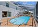 Inviting outdoor pool area featuring a covered patio and ample seating at 6112 Gnarled Oak Dr, Englewood, FL 34223