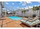 Relaxing screened-in pool area with lounge chairs, perfect for sunny days and relaxation at 6112 Gnarled Oak Dr, Englewood, FL 34223