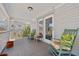 Covered porch with rocking chairs, offering a relaxing outdoor space at 6112 Gnarled Oak Dr, Englewood, FL 34223