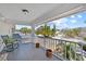 Spacious porch featuring rocking chairs and views of the street and sky at 6112 Gnarled Oak Dr, Englewood, FL 34223