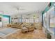 Sunroom with wicker furniture, tile flooring and decorative art at 6112 Gnarled Oak Dr, Englewood, FL 34223