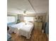 Cozy bedroom with two twin beds, warm lighting, and laminate floors at 715 Fairmount Dr, North Port, FL 34287