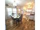 Inviting dining area with wood floors, glass table, with easy access to the kitchen for convenient entertaining at 715 Fairmount Dr, North Port, FL 34287