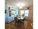 Charming dining room featuring built-in display cabinets, stylish light fixture, and natural light at 715 Fairmount Dr, North Port, FL 34287