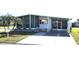Well-maintained single-story home featuring a screened-in porch, covered parking, and a beautifully landscaped yard at 715 Fairmount Dr, North Port, FL 34287