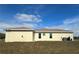 Tan one-story home with new windows and lush green grass at 8136 Sweden Blvd, Punta Gorda, FL 33982