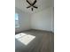 Bedroom with tile flooring, a ceiling fan, and a large window at 8136 Sweden Blvd, Punta Gorda, FL 33982