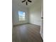 Cozy bedroom with wood-look tile flooring, a bright window, and fresh white paint at 8136 Sweden Blvd, Punta Gorda, FL 33982
