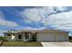 Inviting single-story home with a neutral-colored exterior, well-maintained lawn, and a convenient two-car garage at 8136 Sweden Blvd, Punta Gorda, FL 33982