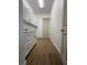 Laundry room features upper and lower cabinets and wood-look tile flooring at 8136 Sweden Blvd, Punta Gorda, FL 33982