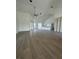 Spacious living room featuring sleek wood-look tile flooring, high ceilings, and ample natural light at 8136 Sweden Blvd, Punta Gorda, FL 33982