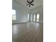 Bright living room featuring tile flooring, ceiling fan, and access to the outdoor area at 8136 Sweden Blvd, Punta Gorda, FL 33982