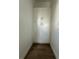 Hallway storage space with white cabinets and wood-look tile flooring at 8136 Sweden Blvd, Punta Gorda, FL 33982