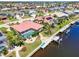 Aerial view of a single story home with a pool, boat dock, and waterfront canal access at 815 Via Formia, Punta Gorda, FL 33950
