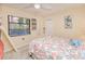 Bright bedroom with a window view, coastal decor, and fan at 815 Via Formia, Punta Gorda, FL 33950