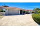 Charming one story home featuring a spanish tile roof, two car garage, and an inviting driveway at 815 Via Formia, Punta Gorda, FL 33950