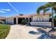 Attractive one story home featuring a spanish tile roof, two car garage, and a lovely entryway at 815 Via Formia, Punta Gorda, FL 33950