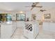 Bright kitchen showcasing stainless steel appliances, granite countertops, and an island with wine storage at 815 Via Formia, Punta Gorda, FL 33950