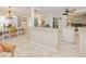 Open concept kitchen with stone countertops, white cabinets, stainless steel appliances, and breakfast bar at 815 Via Formia, Punta Gorda, FL 33950