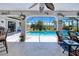 Screened lanai boasts a view of the pool, waterfront, and coastal decor, perfect for relaxing and entertaining at 815 Via Formia, Punta Gorda, FL 33950