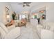 Bright living room showcasing vaulted ceilings, tile flooring, and an open layout into dining and kitchen areas at 815 Via Formia, Punta Gorda, FL 33950