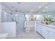 Bright bathroom with glass enclosed shower, soaking tub, double vanity, and tile flooring at 815 Via Formia, Punta Gorda, FL 33950
