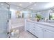 Spacious bathroom featuring a glass shower, a soaking tub, and double sinks with plenty of counter space at 815 Via Formia, Punta Gorda, FL 33950