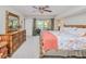 Bright main bedroom with wood furnishings, view of the pool area, and neutral carpeting at 815 Via Formia, Punta Gorda, FL 33950