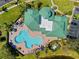 Aerial perspective of community clubhouse with a pool, lounge chairs, and lush landscape at 9020 Eagle Bay Ct, North Port, FL 34287