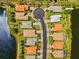 An aerial view of a home located in a cul-de-sac on a large body of water at 9020 Eagle Bay Ct, North Port, FL 34287