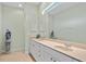 Bathroom features dual sinks, large mirror, and ample storage at 9020 Eagle Bay Ct, North Port, FL 34287