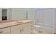 Bathroom features sink, vanity, toilet, and shower with glass door at 9020 Eagle Bay Ct, North Port, FL 34287