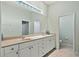 Bathroom features double sinks, a large mirror and natural lighting at 9020 Eagle Bay Ct, North Port, FL 34287