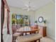 Bright dining area with view of patio, wood table, bench, and ceiling fan at 9020 Eagle Bay Ct, North Port, FL 34287