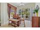 Dining area with view of patio, featuring wood table, chairs, and bench at 9020 Eagle Bay Ct, North Port, FL 34287
