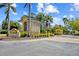 A security entrance gate leading into a vibrant community with lush landscaping at 9020 Eagle Bay Ct, North Port, FL 34287