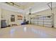 Spacious two car garage featuring an automatic door, and two windows at 9020 Eagle Bay Ct, North Port, FL 34287
