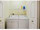 Bright laundry area features a washer and dryer, and shelving for storage at 9020 Eagle Bay Ct, North Port, FL 34287